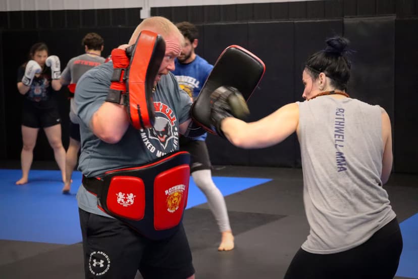 practicing kickboxing techniques in class